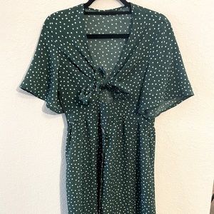 Green with white dots. Ties in the chest area.